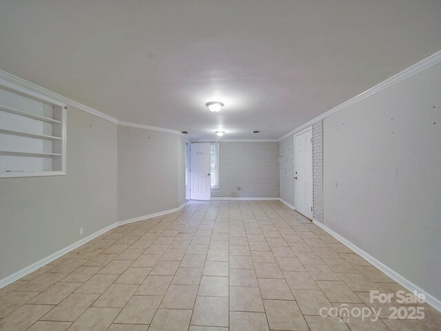 363 Sowers Rd, Linwood, NC 27299 - unfurnished room featuring crown molding, brick wall, baseboards, and built in shelves