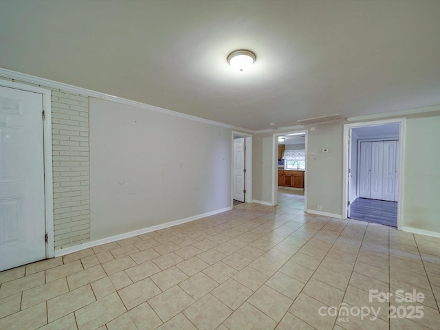 363 Sowers Rd, Linwood, NC 27299 - empty room with crown molding, light tile patterned flooring, and baseboards