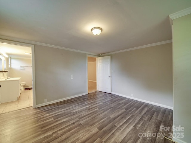 363 Sowers Rd, Linwood, NC 27299 - unfurnished bedroom with wood finished floors, baseboards, ensuite bathroom, ornamental molding, and a sink