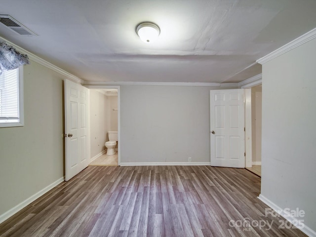 363 Sowers Rd, Linwood, NC 27299 - spare room featuring wood finished floors, crown molding, and baseboards