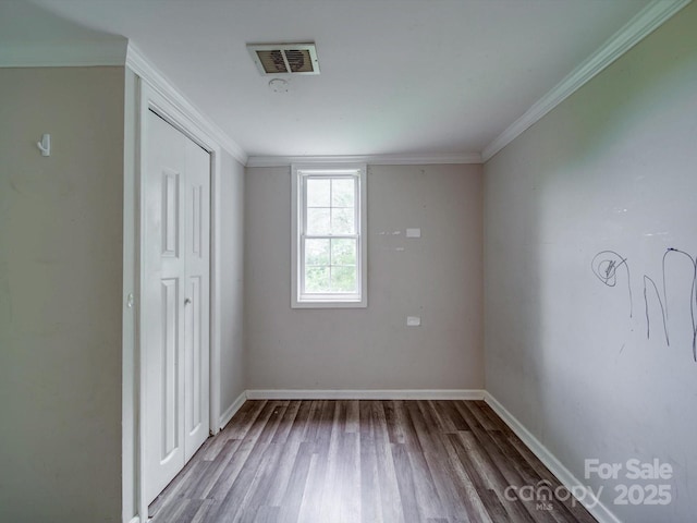 363 Sowers Rd, Linwood, NC 27299 - unfurnished bedroom featuring wood finished floors, baseboards, and crown molding