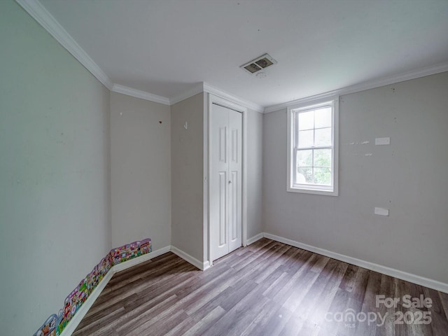 363 Sowers Rd, Linwood, NC 27299 - unfurnished bedroom featuring wood finished floors, baseboards, a closet, and ornamental molding