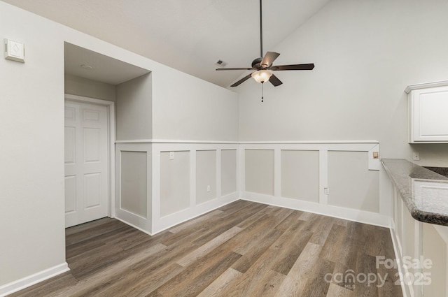 spare room with vaulted ceiling, ceiling fan, and wood finished floors