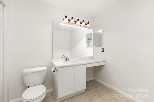 bathroom featuring toilet, tile patterned flooring, and baseboards