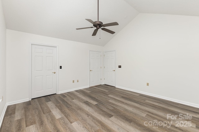 empty room featuring wood finished floors, baseboards, ceiling fan, and high vaulted ceiling