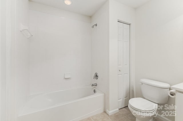 bathroom featuring tile patterned flooring, toilet, a closet, and bathtub / shower combination
