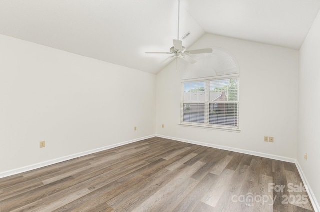 empty room featuring vaulted ceiling, baseboards, visible vents, ceiling fan, and wood finished floors