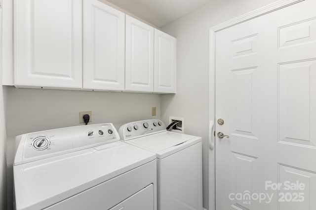washroom with cabinet space and separate washer and dryer