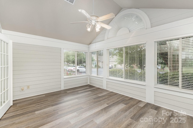 unfurnished sunroom featuring a ceiling fan