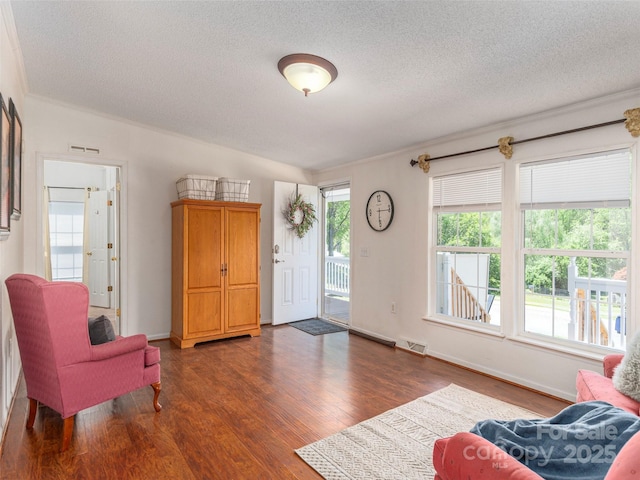 9 Redmond Dr, Alexander, NC 28701 - living area with crown molding, visible vents, a textured ceiling, and wood finished floors