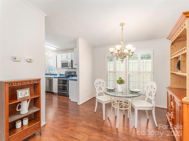 9 Redmond Dr, Alexander, NC 28701 - dining area with crown molding, baseboards, dark wood-type flooring, and a chandelier