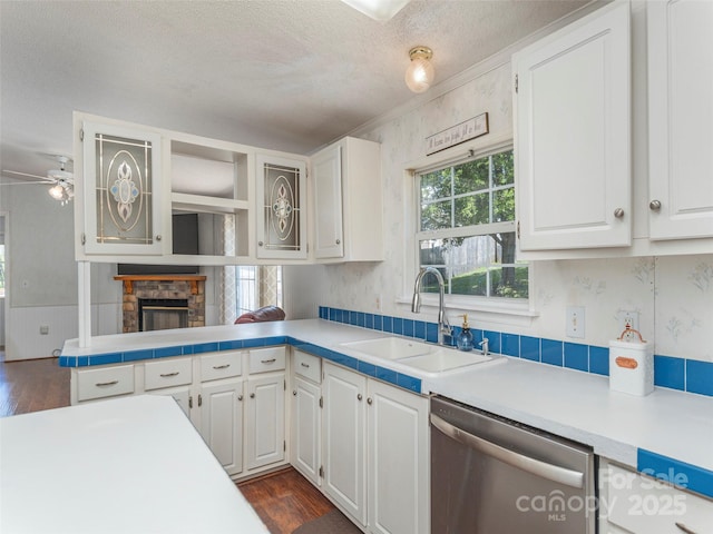 9 Redmond Dr, Alexander, NC 28701 - kitchen with a sink, dark wood finished floors, a fireplace, dishwasher, and white cabinetry