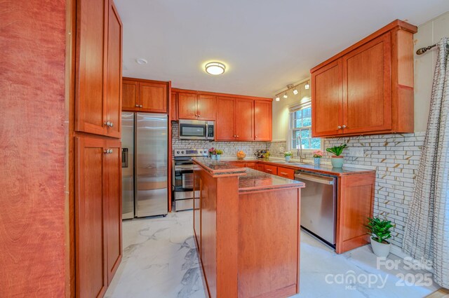 6 Chipmunk Cove Rd, Asheville, NC 28804 - kitchen featuring stainless steel appliances, brown cabinetry, tasteful backsplash, a kitchen island, and marble finish floor