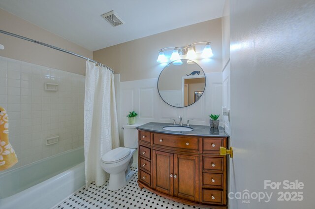 6 Chipmunk Cove Rd, Asheville, NC 28804 - bathroom featuring toilet, shower / bath combo with shower curtain, vanity, visible vents, and wainscoting