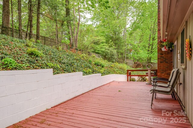 6 Chipmunk Cove Rd, Asheville, NC 28804 - wooden terrace featuring a wooded view and a fenced backyard