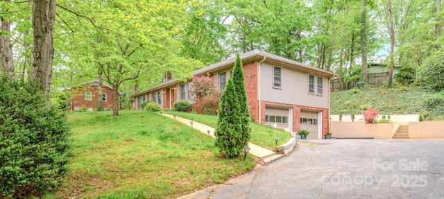 6 Chipmunk Cove Rd, Asheville, NC 28804 - view of front of home featuring a front lawn, brick siding, a garage, and aphalt driveway