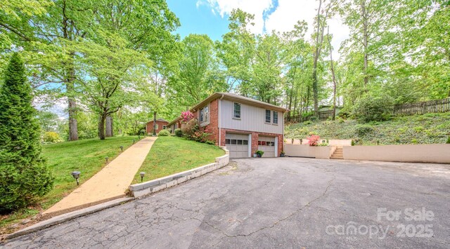 6 Chipmunk Cove Rd, Asheville, NC 28804 - view of side of home with a garage, a lawn, aphalt driveway, brick siding, and stairs