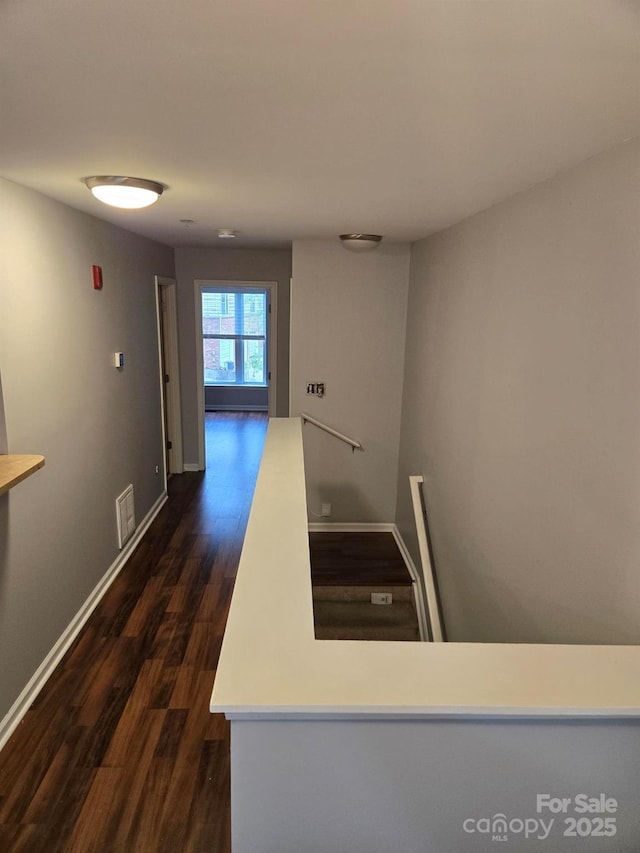 521 Donatello Ave, Charlotte, NC 28205 - hallway featuring an upstairs landing, dark wood-type flooring, and baseboards
