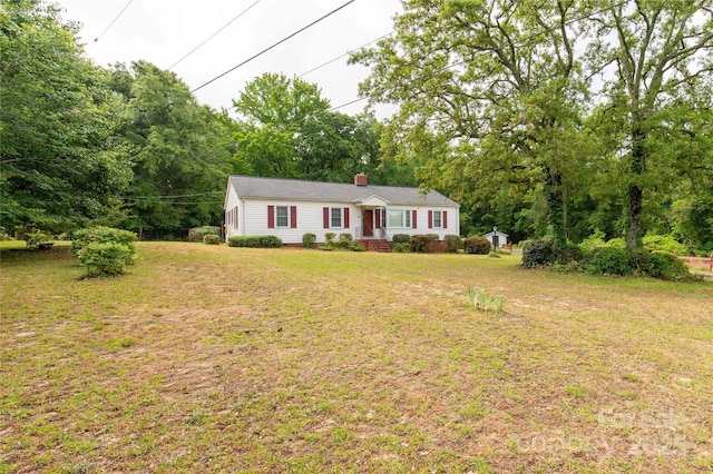 single story home featuring a front lawn and a chimney