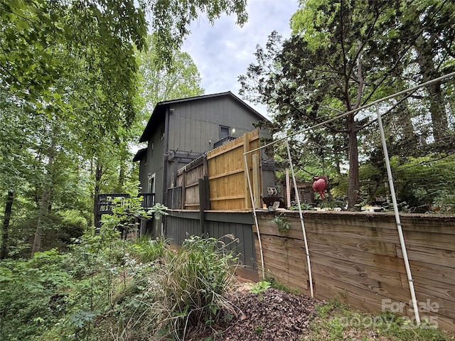 view of side of home with fence
