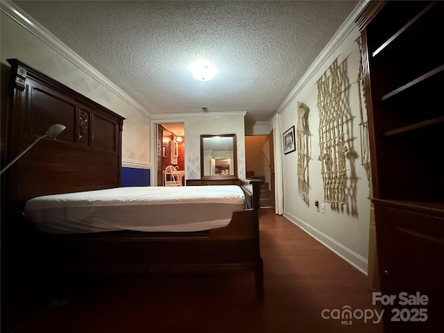 bedroom with ornamental molding, a textured ceiling, baseboards, and dark wood finished floors