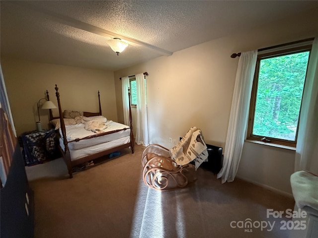 carpeted bedroom featuring a textured ceiling