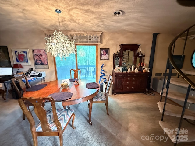 dining room with a chandelier, visible vents, and carpet