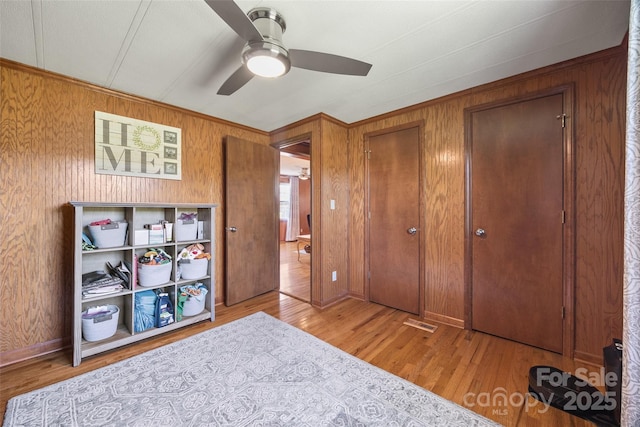 105 Carrie Ln Unit 3, Cherryville, NC 28021 - bedroom featuring ceiling fan, wood walls, visible vents, and wood finished floors