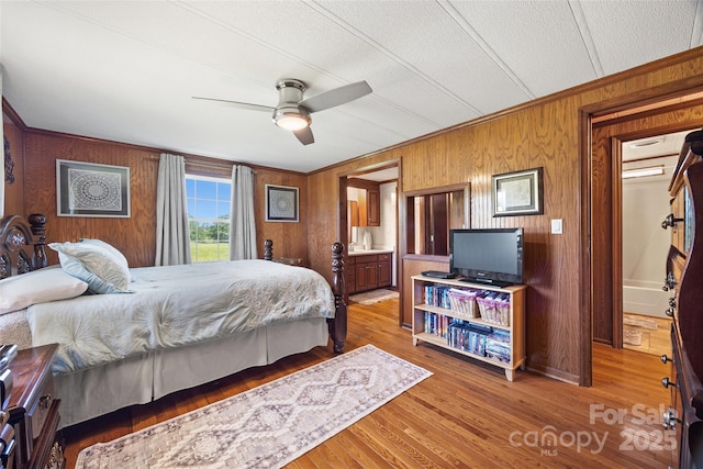 105 Carrie Ln Unit 3, Cherryville, NC 28021 - bedroom with a ceiling fan, a textured ceiling, wooden walls, crown molding, and wood finished floors