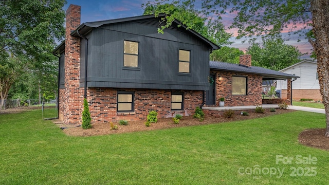 606 Hillcrest St, Hudson, NC 28638 - tri-level home with a chimney, a yard, brick siding, and fence