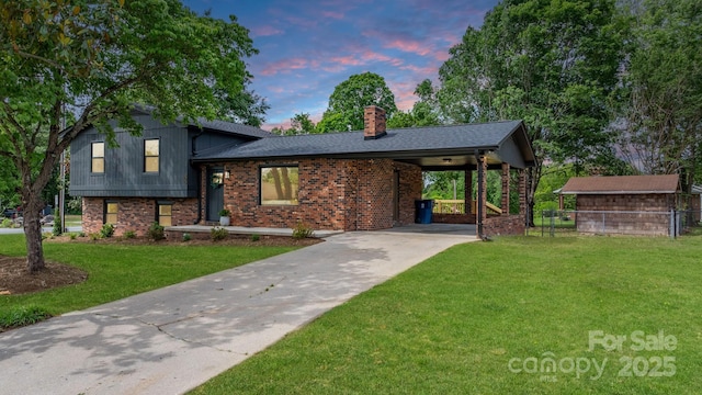 606 Hillcrest St, Hudson, NC 28638 - tri-level home featuring an attached carport, a chimney, a front lawn, brick siding, and driveway