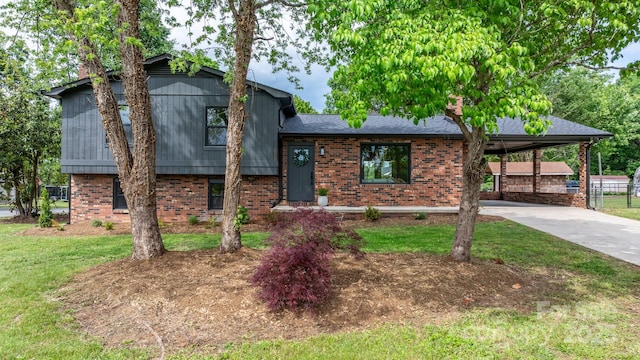 606 Hillcrest St, Hudson, NC 28638 - split level home featuring a chimney, a carport, concrete driveway, a front yard, and brick siding
