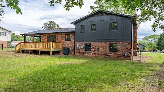 606 Hillcrest St, Hudson, NC 28638 - rear view of house featuring brick siding, fence, a deck, and a lawn