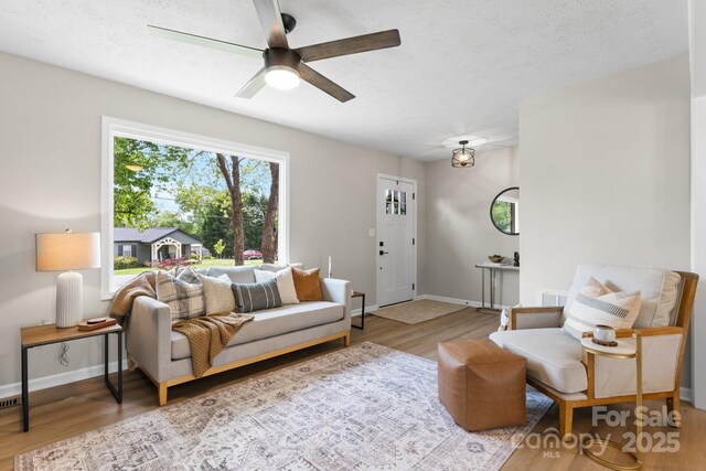 606 Hillcrest St, Hudson, NC 28638 - living area with baseboards, a ceiling fan, and wood finished floors