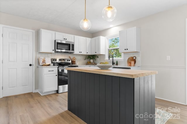 606 Hillcrest St, Hudson, NC 28638 - kitchen featuring wooden counters, decorative backsplash, white cabinets, and appliances with stainless steel finishes