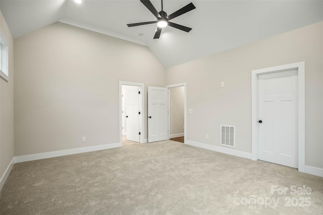 unfurnished bedroom featuring lofted ceiling, baseboards, visible vents, and carpet