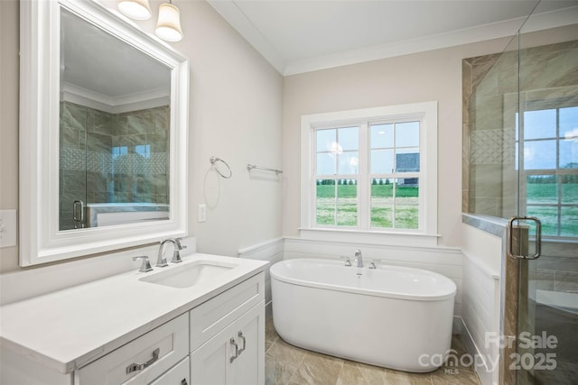 full bath with a wainscoted wall, a shower stall, a freestanding tub, vanity, and ornamental molding