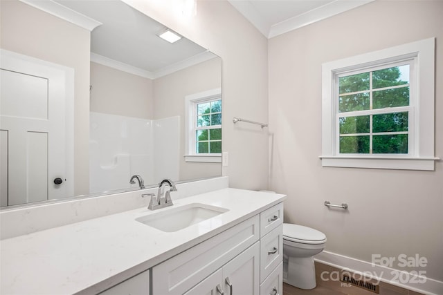bathroom with toilet, a shower, vanity, crown molding, and baseboards