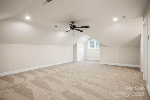 additional living space with lofted ceiling, baseboards, and light colored carpet