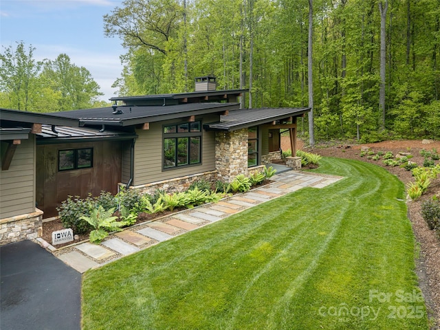391 High Hickory Trl, Swannanoa, NC 28778 - view of front of home featuring stone siding, a front yard, and a chimney