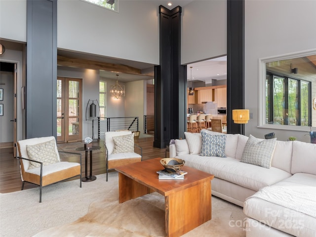 391 High Hickory Trl, Swannanoa, NC 28778 - living area featuring a high ceiling, a chandelier, and light wood-style floors