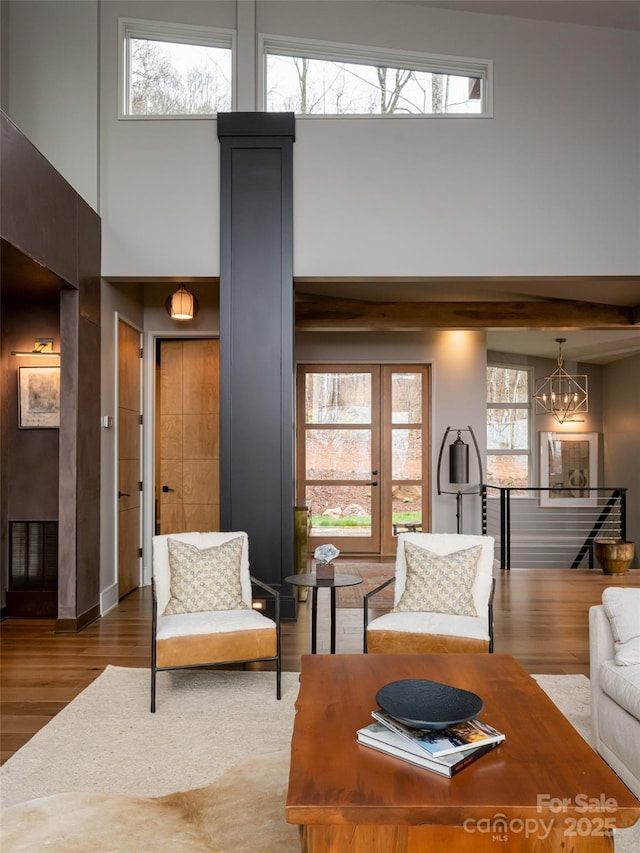 391 High Hickory Trl, Swannanoa, NC 28778 - living area with wood finished floors, plenty of natural light, a high ceiling, and a chandelier