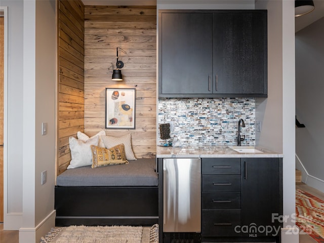 391 High Hickory Trl, Swannanoa, NC 28778 - indoor wet bar featuring freestanding refrigerator, decorative backsplash, wooden walls, and baseboards