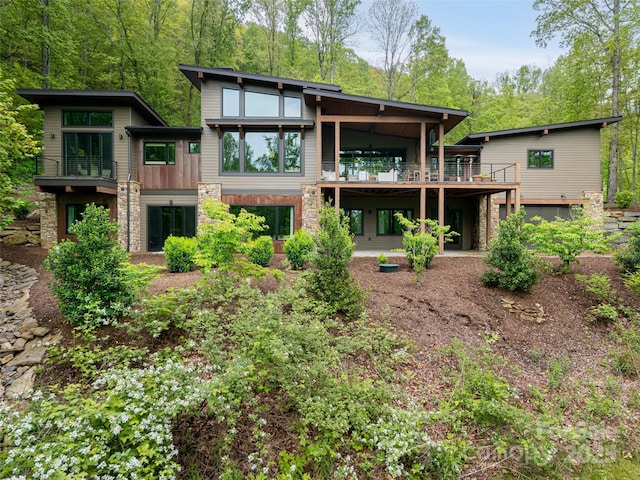 391 High Hickory Trl, Swannanoa, NC 28778 - rear view of house featuring stone siding, a balcony, and a deck