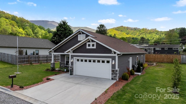 craftsman-style home featuring concrete driveway, stone siding, a front lawn, and fence