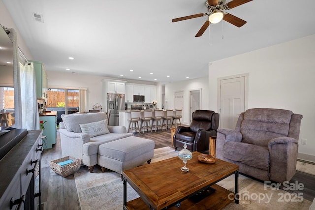 living area featuring a ceiling fan, recessed lighting, light wood finished floors, and visible vents