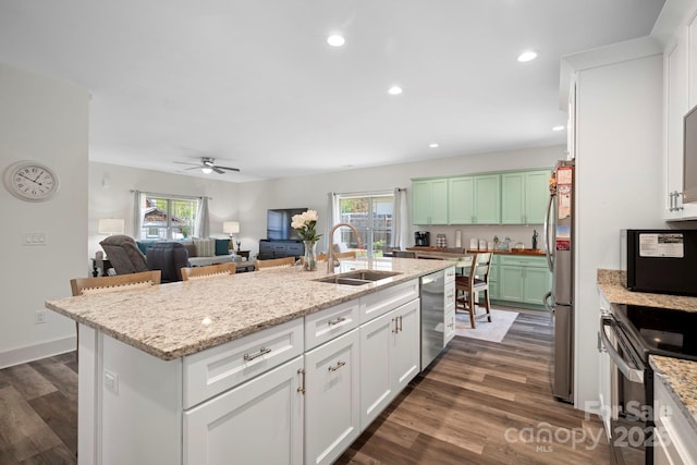 kitchen with plenty of natural light, stainless steel appliances, dark wood-type flooring, and a sink
