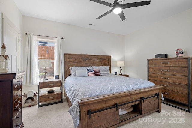 bedroom with ceiling fan, light carpet, and visible vents