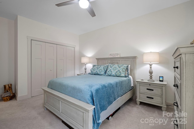 bedroom with light colored carpet, a closet, and ceiling fan