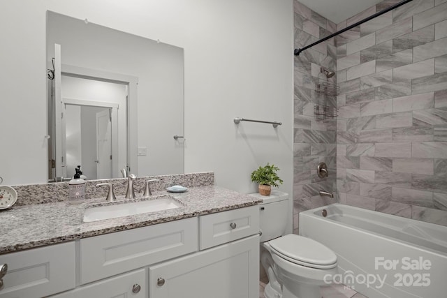 bathroom featuring toilet, vanity, and bathtub / shower combination